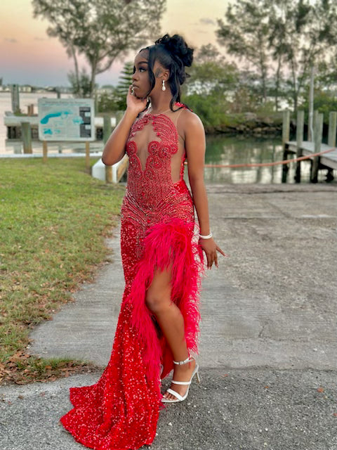 Radiant Red Sequined Gown with Jeweled Bodice and Feather Accent