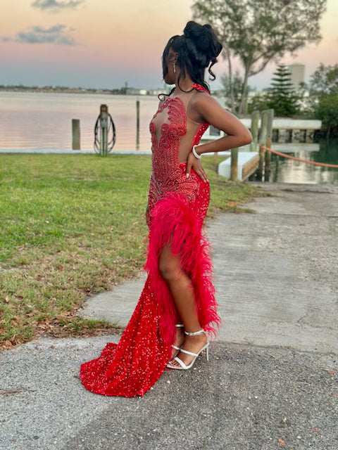 Radiant Red Sequined Gown with Jeweled Bodice and Feather Accent