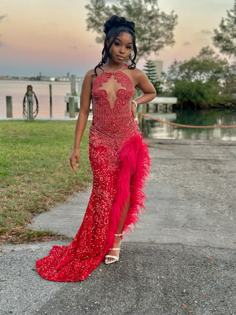 Radiant Red Sequined Gown with Jeweled Bodice and Feather Accent