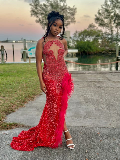 Radiant Red Sequined Gown with Jeweled Bodice and Feather Accent